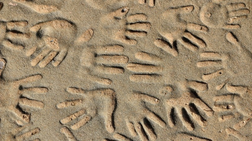 Handprints in the Sand wallpaper
